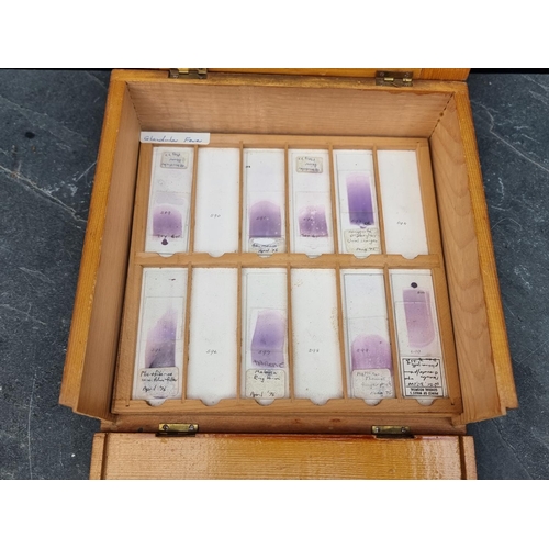 1423 - A cased set of haematology microscope slides; and other related items.