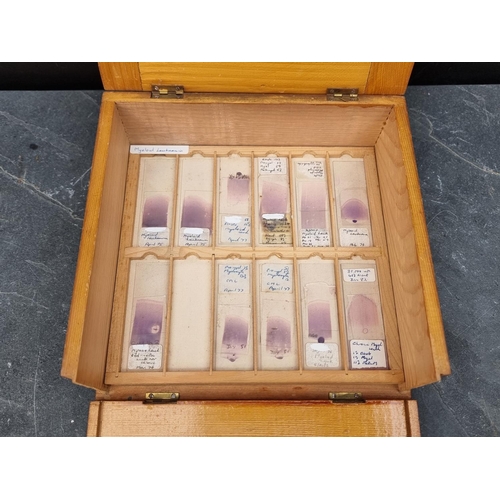 1423 - A cased set of haematology microscope slides; and other related items.