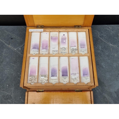 1423 - A cased set of haematology microscope slides; and other related items.