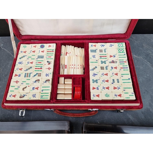 1432 - A bone and bamboo mahjong set; with a set of four lacquered counter stands.