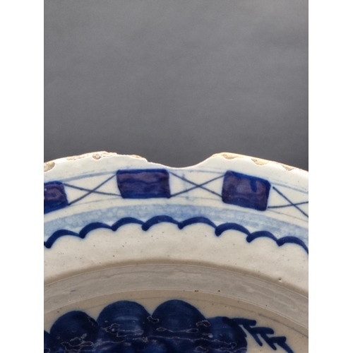 1509 - An 18th century delft blue and white charger, 35.5cm diameter, (rim chips).