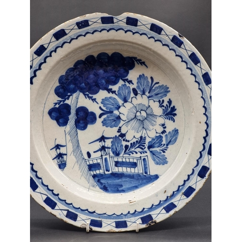 1509 - An 18th century delft blue and white charger, 35.5cm diameter, (rim chips).