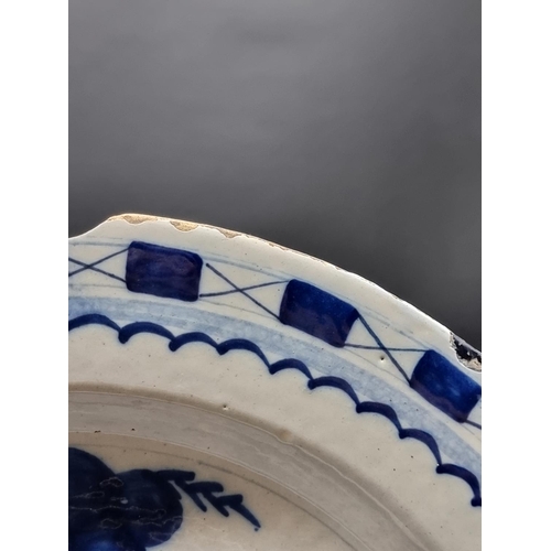 1509 - An 18th century delft blue and white charger, 35.5cm diameter, (rim chips).