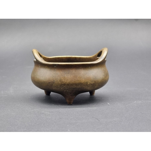 1528 - A Chinese bronze twin handled tripod censer, Xuande six character seal mark to base, 12cm diame... 