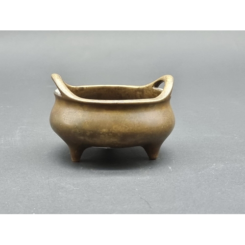 1528 - A Chinese bronze twin handled tripod censer, Xuande six character seal mark to base, 12cm diame... 