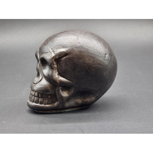 1533 - An iron skull, 14.5cm high.