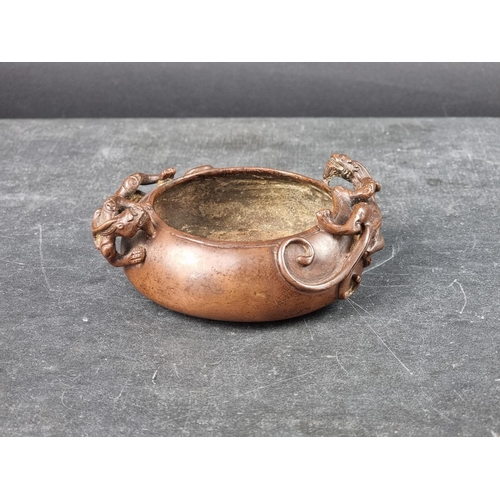 1538 - A Chinese bronze twin handled censer, archaistic seal mark to base, with chilong handles, 12cm wide.... 