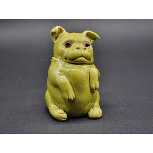 A scarce Burmantofts faience seated dog, model no. 1991, with glass inset eyes, 13.5cm high.