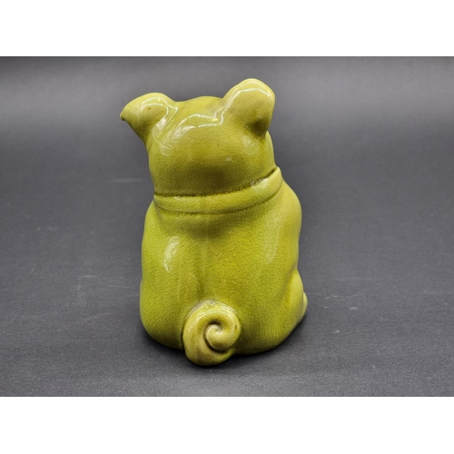 1541 - A scarce Burmantofts faience seated dog, model no. 1991, with glass inset eyes, 13.5cm high.... 