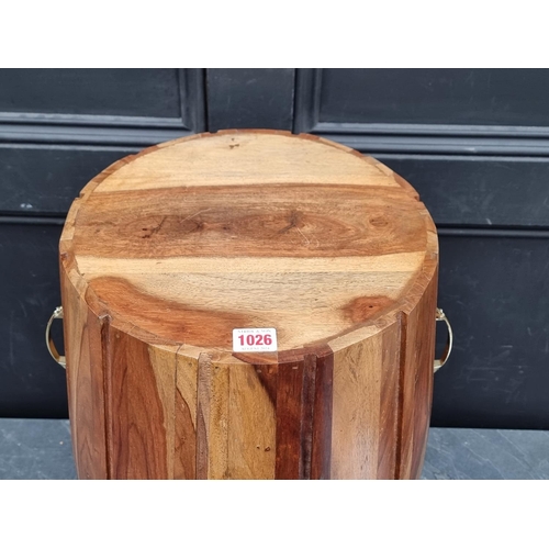 1026 - A hardwood barrel form stool, 56cm high.