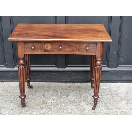 1041 - A 19th century mahogany three drawer side table, on reeded legs, 89.5cm wide.