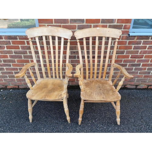 1055 - A pair of antique beech and elm lath back kitchen armchairs.En suite with the previous lot.... 