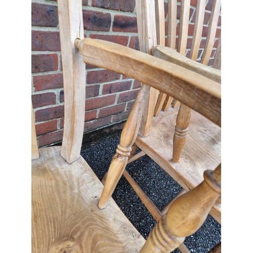 1055 - A pair of antique beech and elm lath back kitchen armchairs.En suite with the previous lot.... 