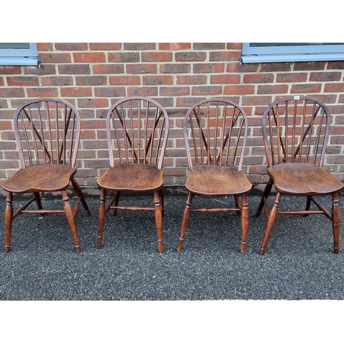 1057 - A near set of four 19th century yew and elm Windsor armchairs, comprising two similar pairs.... 