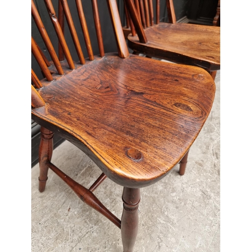 1057 - A near set of four 19th century yew and elm Windsor armchairs, comprising two similar pairs.... 