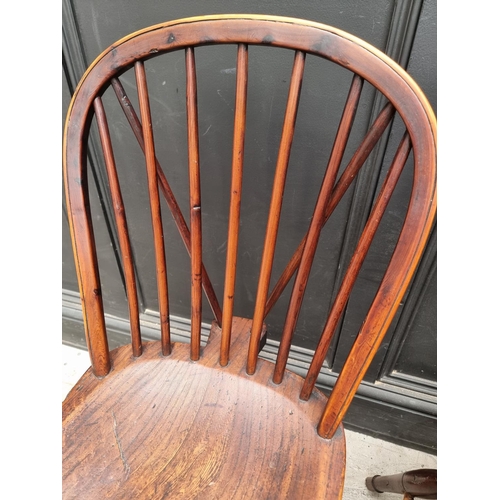 1057 - A near set of four 19th century yew and elm Windsor armchairs, comprising two similar pairs.... 