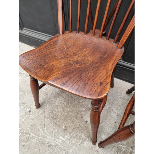 1057 - A near set of four 19th century yew and elm Windsor armchairs, comprising two similar pairs.... 