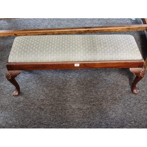 1097 - An 18th century style walnut long low stool, 96cm wide.