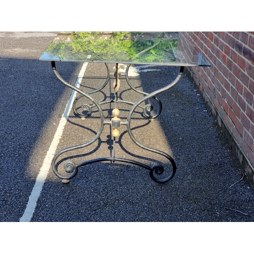 1113 - A black painted steel table base, 140cm wide, with associated glass top.