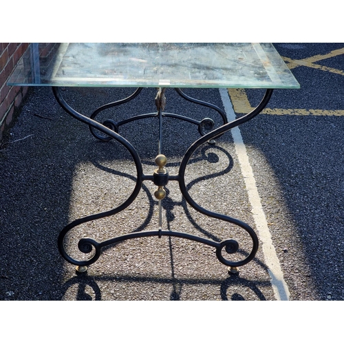 1113 - A black painted steel table base, 140cm wide, with associated glass top.