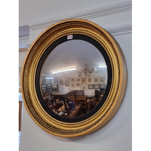 1116 - A Regency gilt framed convex wall mirror, 60cm diameter.