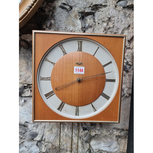 1144 - A 1950s Kienzle wall clock, 28.5cm wide, with weights and pendulum.