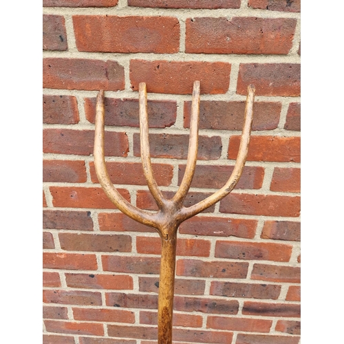 1326 - A vintage beech hayfork, with branded initials, 143cm long.