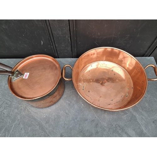 1358 - A large copper twin handled preserving pan, 48cm wide; together with a large saucepan and cover. (2)... 