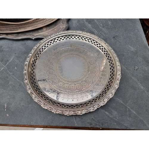 1422 - A collection of silver plated trays and salvers, to include a twin handled example, 69cm wide. ... 