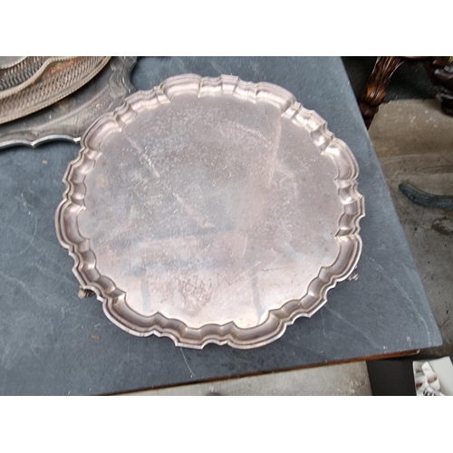 1422 - A collection of silver plated trays and salvers, to include a twin handled example, 69cm wide. ... 