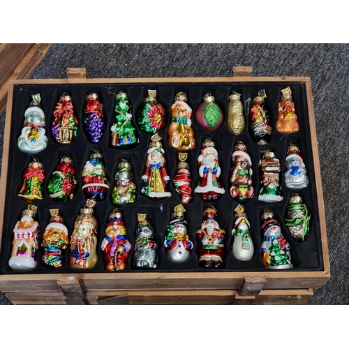 1504 - A good collection of Thomas Pacconi 2004 30th anniversary Christmas decorations, in four pine c... 