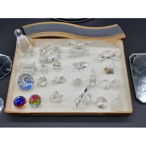 1574 - A collection of Swarovski crystal; together with related display stands.