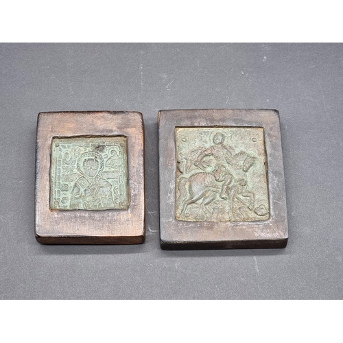 1582 - Two antique small copper alloy Russian icons, each in wood mount, largest 8.5 x 7.5cm.... 