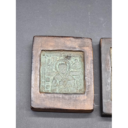 1582 - Two antique small copper alloy Russian icons, each in wood mount, largest 8.5 x 7.5cm.... 