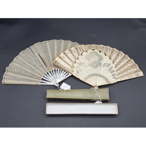 1586 - A Victorian mother-of-pearl fan, the guards 24cm long; together with another bone and silk example, ... 