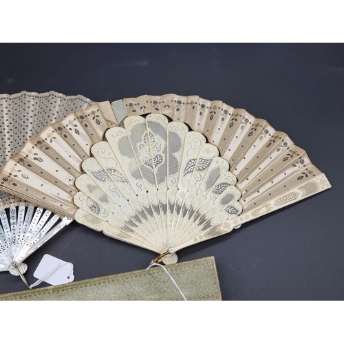 1586 - A Victorian mother-of-pearl fan, the guards 24cm long; together with another bone and silk example, ... 