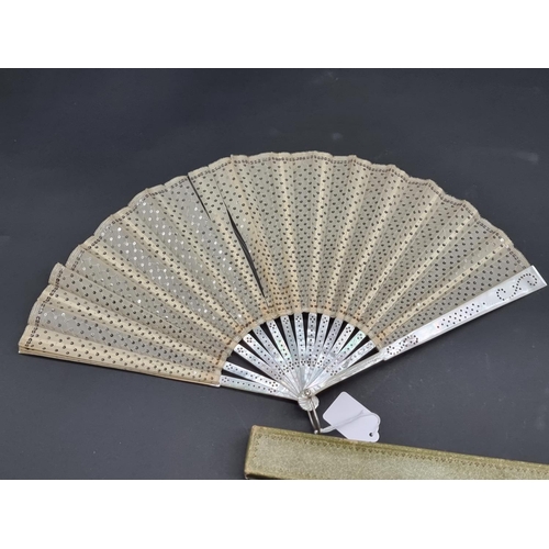 1586 - A Victorian mother-of-pearl fan, the guards 24cm long; together with another bone and silk example, ... 