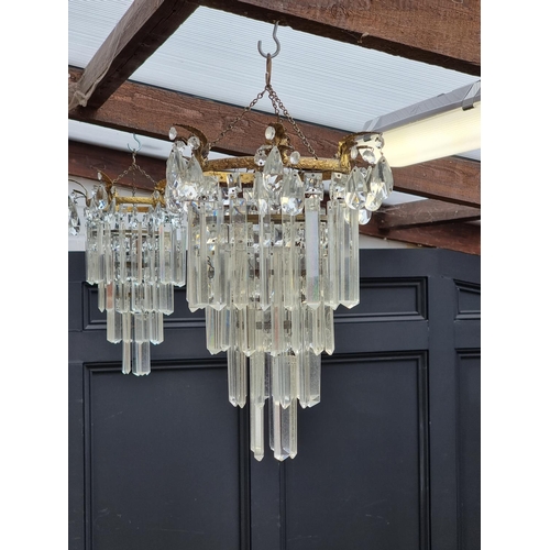 1613 - An old pair of brass and glass lustre four tier chandeliers, 40cm high. 