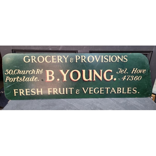 1627 - Advertising: an old painted chipboard 'B Young, Grocery' sign, 38.5 x 126cm.