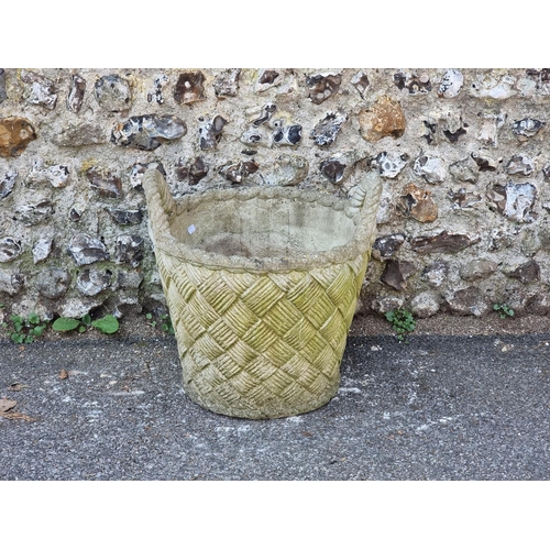 1643 - A large composition stone basket weave effect twin handled urn, 52cm high.