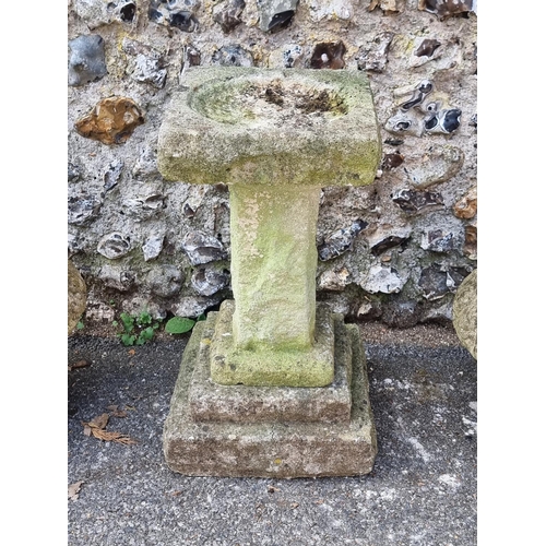 1644 - A weathered composition pedestal birdbath, 66.5cm high; together with a similar pair of urns, 37cm h... 