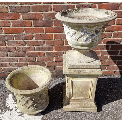 1651 - A composition stone urn and pedestal, 93cm high; together with another similar urn. (2)... 