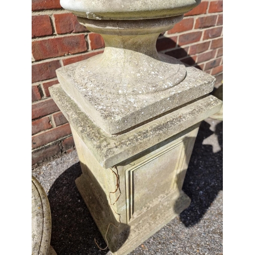 1651 - A composition stone urn and pedestal, 93cm high; together with another similar urn. (2)... 