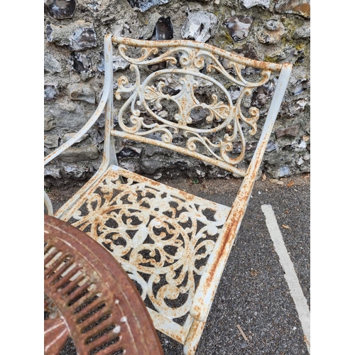 1654 - A set of four cast iron garden armchairs, 50.5cm wide; together with a similar table, 69.5cm diamete... 