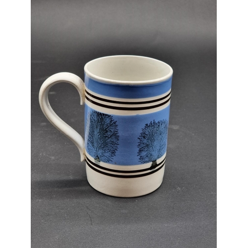 1526 - A 19th century Mochaware mug, 13cm high.