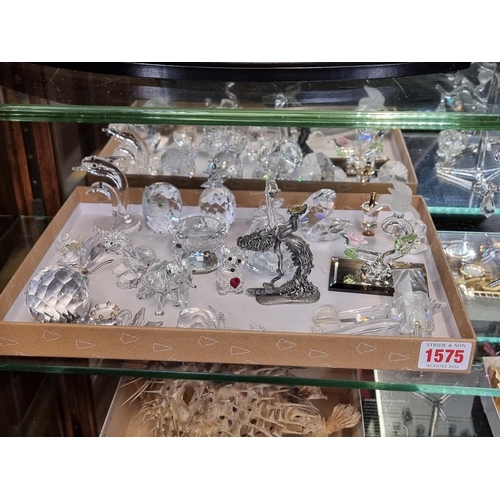 1575 - A collection of Swarovski crystal; together with related display stands.