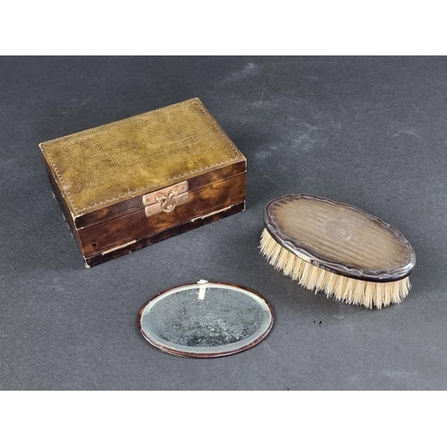 118 - A cased silver mounted brush; together with a leather mounted mirror.