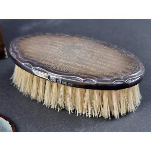 118 - A cased silver mounted brush; together with a leather mounted mirror.