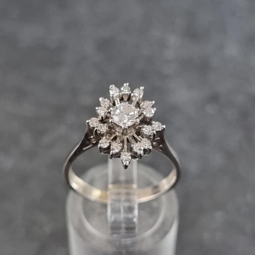 120 - A diamond starburst cluster ring, set central brilliant cut diamond of approximately 0.25ct surround... 