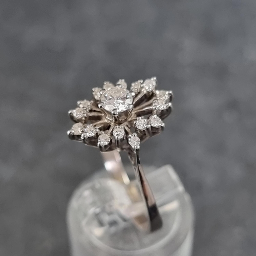 120 - A diamond starburst cluster ring, set central brilliant cut diamond of approximately 0.25ct surround... 